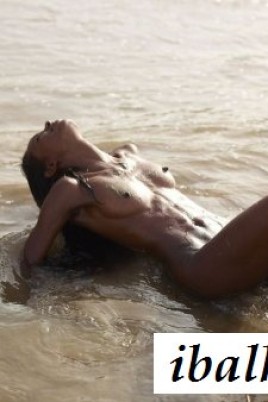 Худенькая раздетая негритянка развлекается в море